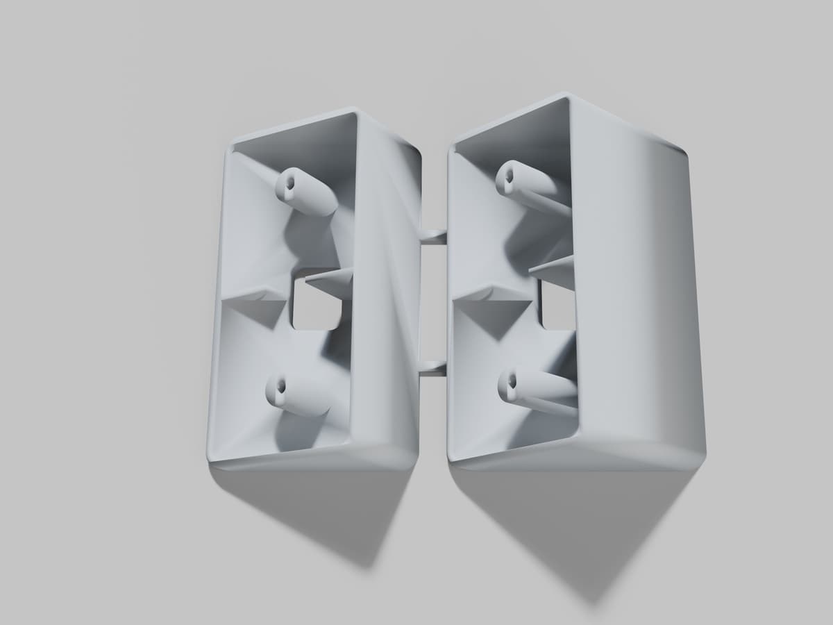 A rendering of a two piece doorbell angle wedge kit for a Ring video doorbell, one 30 degree wedge and one 45 degree wedge joined by two small bars