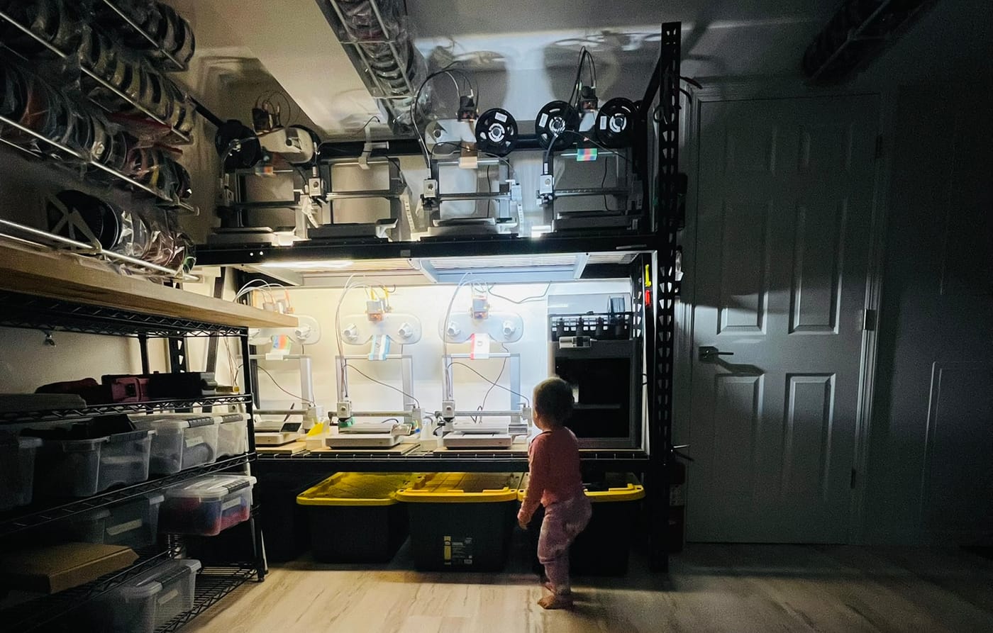 A row of 3D printers running in the home workshop where 3D Prints Fast got its start.